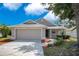 Charming single-story home with a two-car garage, manicured landscaping, and a welcoming walkway at 5009 72Nd E Ct, Bradenton, FL 34203