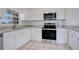 Well-equipped kitchen with stainless steel appliances, white cabinets, and granite countertops at 5009 72Nd E Ct, Bradenton, FL 34203