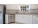 Close-up of the kitchen with stainless steel appliances, white cabinets and granite countertops at 5009 72Nd E Ct, Bradenton, FL 34203