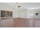 Bright and airy living room with hardwood floors and a sliding glass door to a screened-in lanai at 5009 72Nd E Ct, Bradenton, FL 34203
