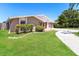 Landscaped front yard featuring a well-maintained lawn and complementary foliage at 7221 King Arthur Dr, Port Richey, FL 34668