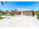 Charming single-story home featuring a well-maintained lawn, driveway, and attached garage at 7221 King Arthur Dr, Port Richey, FL 34668