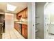 The open kitchen offers granite countertops, tile floors, cabinetry, and stainless steel appliances at 7221 King Arthur Dr, Port Richey, FL 34668