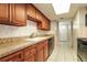 Well-lit kitchen featuring granite countertops, cabinetry, and tile backsplash at 7221 King Arthur Dr, Port Richey, FL 34668