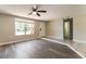 The living room has hardwood floors, a ceiling fan, and an entrance to the bathroom at 7221 King Arthur Dr, Port Richey, FL 34668