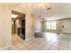 Open-concept living area with tile and hardwood floors offers a gateway to the kitchen at 7221 King Arthur Dr, Port Richey, FL 34668