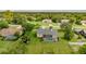 Aerial view of a house with screened pool and spacious backyard surrounded by trees at 9475 Dunkirk Rd, Spring Hill, FL 34608