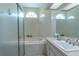 Bright bathroom featuring a soaking tub, shower, and a large vanity at 9475 Dunkirk Rd, Spring Hill, FL 34608