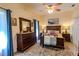 Comfortable bedroom with a ceiling fan, dresser, and a stylish bed at 9475 Dunkirk Rd, Spring Hill, FL 34608