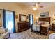 Comfortable bedroom with a ceiling fan, dresser, and a stylish bed at 9475 Dunkirk Rd, Spring Hill, FL 34608