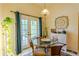 Charming breakfast nook with glass table, wicker chairs, and patio access at 9475 Dunkirk Rd, Spring Hill, FL 34608