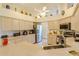 Spacious kitchen with stainless steel appliances, light cabinets, and tile flooring at 9475 Dunkirk Rd, Spring Hill, FL 34608
