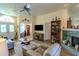 Inviting living room with fireplace, bookshelf, and view into front entryway at 9475 Dunkirk Rd, Spring Hill, FL 34608
