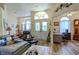 Bright living room with decorative doors, arched window, and home office space at 9475 Dunkirk Rd, Spring Hill, FL 34608