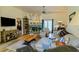 Spacious living room featuring a fireplace, ceiling fan and stylish furnishings at 9475 Dunkirk Rd, Spring Hill, FL 34608