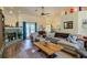 Cozy living room featuring a fireplace, plush seating, and hardwood floors at 9475 Dunkirk Rd, Spring Hill, FL 34608