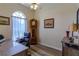 Bright home office with a large arched window and hardwood floors at 9475 Dunkirk Rd, Spring Hill, FL 34608