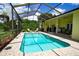 Inviting screened-in pool area featuring a sparkling pool, lounge chairs, and a covered patio at 9475 Dunkirk Rd, Spring Hill, FL 34608