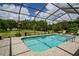 Beautiful screened pool with tiled deck and serene backyard view at 9475 Dunkirk Rd, Spring Hill, FL 34608