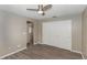 This bedroom offers neutral walls, wood-look floors and a ceiling fan at 2597 Countryside Blvd # 204, Clearwater, FL 33761