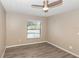 This bedroom provides natural light with a large window and wood-look floors at 2597 Countryside Blvd # 204, Clearwater, FL 33761