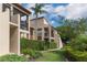 Well-maintained condo with green landscape featuring mature trees, shrubs, and inviting lawns at 2597 Countryside Blvd # 204, Clearwater, FL 33761