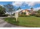 Community signage and building exterior in a landscaped setting at 2597 Countryside Blvd # 204, Clearwater, FL 33761