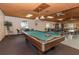 Relaxing community center game room with a billiard table and plenty of seating, with shelves of books to read at 2597 Countryside Blvd # 204, Clearwater, FL 33761