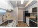 Updated kitchen featuring stainless steel appliances, granite counters, subway tile backsplash, and white cabinets at 2597 Countryside Blvd # 204, Clearwater, FL 33761