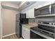 Bright kitchen features stainless steel appliances, wood-style floors, and white cabinets at 2597 Countryside Blvd # 204, Clearwater, FL 33761