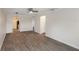 Open living room with wood-style floors, ceiling fan, and lots of natural light at 2597 Countryside Blvd # 204, Clearwater, FL 33761