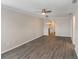 Bright living room featuring modern ceiling fan, contemporary light fixtures, and beautiful laminate flooring at 2597 Countryside Blvd # 204, Clearwater, FL 33761
