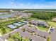 Community aerial view of pools, clubhouse, tennis courts, parking and nearby residences at 3061 Hollow Hickory Pl, Wesley Chapel, FL 33543