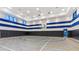 Indoor basketball court with blue and white accents at 3061 Hollow Hickory Pl, Wesley Chapel, FL 33543