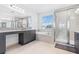 Bright and spacious bathroom featuring a soaking tub, glass-enclosed shower, and gray vanities at 3061 Hollow Hickory Pl, Wesley Chapel, FL 33543