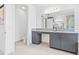 Modern bathroom featuring granite countertops, gray cabinets, and bright lighting at 3061 Hollow Hickory Pl, Wesley Chapel, FL 33543