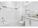 Clean bathroom with white tiles, shower-tub combo, and sleek vanity at 3061 Hollow Hickory Pl, Wesley Chapel, FL 33543