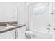 Bright bathroom features white cabinets, gray counters, and shower-tub combo at 3061 Hollow Hickory Pl, Wesley Chapel, FL 33543