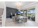 Bright dining area with stylish lighting and elegant decor near outdoor patio at 3061 Hollow Hickory Pl, Wesley Chapel, FL 33543