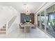 Bright dining area with stylish lighting, elegant decor, and sliding glass doors leading to the outdoor space at 3061 Hollow Hickory Pl, Wesley Chapel, FL 33543