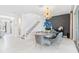 Bright dining area with stylish lighting, elegant decor, and stairs at 3061 Hollow Hickory Pl, Wesley Chapel, FL 33543