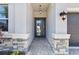 The elegant entryway features stone accents, a modern light fixture, and a double door entrance at 3061 Hollow Hickory Pl, Wesley Chapel, FL 33543