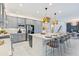 Modern kitchen features an eat-in island with a large island, modern lighting, and sleek appliances at 3061 Hollow Hickory Pl, Wesley Chapel, FL 33543