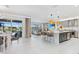 Open-concept kitchen with an island with seating, stainless steel appliances and views of the living room and backyard at 3061 Hollow Hickory Pl, Wesley Chapel, FL 33543