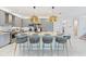 Island kitchen featuring gray cabinets, stainless steel appliances, pendant lighting and seating at 3061 Hollow Hickory Pl, Wesley Chapel, FL 33543
