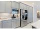 Modern kitchen features sleek appliances, gray cabinets, and ample counter space at 3061 Hollow Hickory Pl, Wesley Chapel, FL 33543