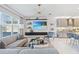 Inviting living room featuring a comfortable sofa, modern decor, a TV, and large windows overlooking the water at 3061 Hollow Hickory Pl, Wesley Chapel, FL 33543