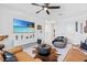 Inviting living room with leather sofas, plush rug, and entertainment center at 3061 Hollow Hickory Pl, Wesley Chapel, FL 33543