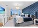 Modern main bedroom with tufted headboard, geometric accent wall, ocean art, and stylish furnishings at 3061 Hollow Hickory Pl, Wesley Chapel, FL 33543