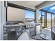 A covered outdoor kitchen features stainless steel appliances and stone accents at 3061 Hollow Hickory Pl, Wesley Chapel, FL 33543